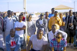 Lucas in the Negev Desert with Eritrean refugees by Anthony Grimes
